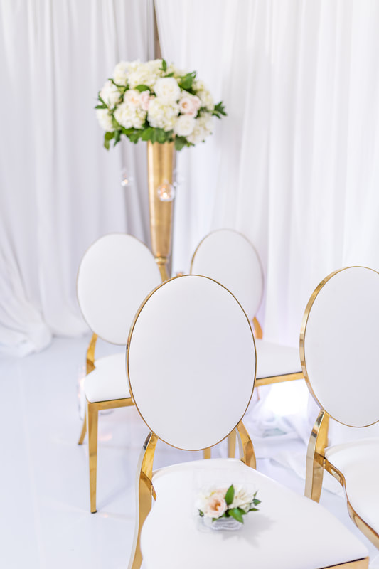 Luxury micro wedding floral arrangements and luxury chairs